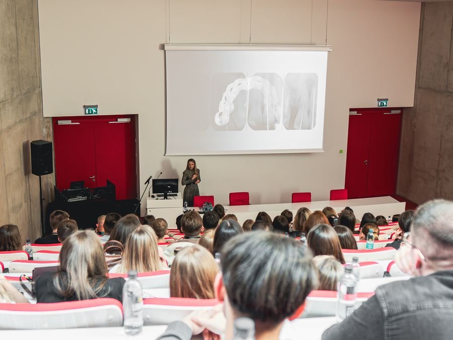 Milda Vitosytė giving a presentation to a full auditorium